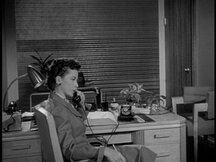Lois in her office, talking on the phone