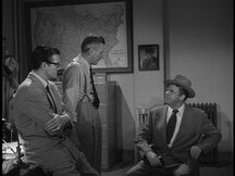 Inspector Henderson about to interrogate Pete while Clark watches